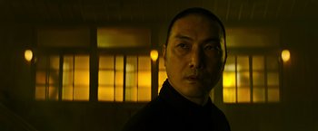 Movie still from “Snake Eyes” (2021), directed by Robert Schwentke – A person wearing a black shirt; Close Up shot, Low angle