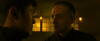 Movie still from “Snake Eyes” (2021), directed by Robert Schwentke – A man looking at another man in a dark room; Close Up shot, Over the shoulder angle