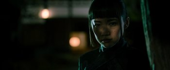 Movie still from “Snake Eyes” (2021), directed by Robert Schwentke – A woman in a black jacket and a black hat; Close Up shot, Low angle