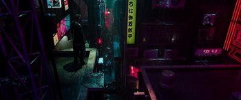 Movie still from “Snake Eyes” (2021), directed by Robert Schwentke – A person standing in a dark room next to a building; Extreme Wide shot, High angle