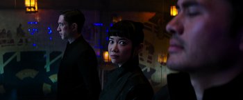 Movie still from “Snake Eyes” (2021), directed by Robert Schwentke – A woman in a black outfit standing next to a man in a black suit; Close Up shot, Over the shoulder angle