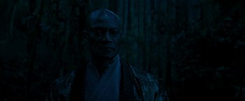 Movie still from “Snake Eyes” (2021), directed by Robert Schwentke – A man in a kimono is standing in the dark; Close Up shot, Low angle