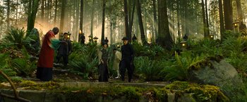 Movie still from “Snake Eyes” (2021), directed by Robert Schwentke – A group of people standing in the woods with guns; Wide shot, High angle