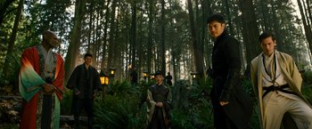 Movie still from “Snake Eyes” (2021), directed by Robert Schwentke – A group of people standing in the woods; Wide shot, Low angle