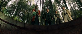 Movie still from “Snake Eyes” (2021), directed by Robert Schwentke – A group of people standing in the woods; Wide shot, Low angle