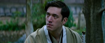 Movie still from “Snake Eyes” (2021), directed by Robert Schwentke – A man in a robe looking to his left; Close Up shot, Low angle