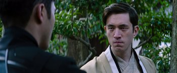 Movie still from “Snake Eyes” (2021), directed by Robert Schwentke – A man in a white shirt and a black tie; Close Up shot, Over the shoulder angle