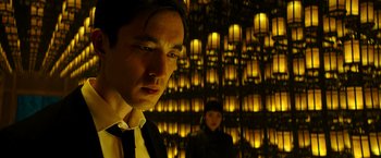 Movie still from “Snake Eyes” (2021), directed by Robert Schwentke – A man and a woman standing next to each other in front of lights; Close Up shot, Over the shoulder angle