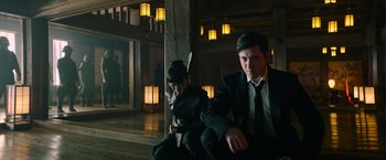 Movie still from “Snake Eyes” (2021), directed by Robert Schwentke – A man and a woman sitting next to each other; Medium shot, Low angle