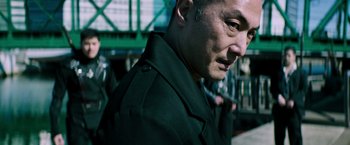 Movie still from “Snake Eyes” (2021), directed by Robert Schwentke – A person wearing a black jacket; Close Up shot, Low angle