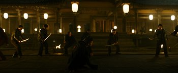 Movie still from “Snake Eyes” (2021), directed by Robert Schwentke – A group of people are playing a sword fight in the dark; Wide shot, High angle