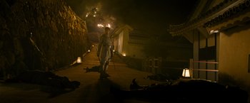 Movie still from “Snake Eyes” (2021), directed by Robert Schwentke – A man dressed as a roman soldier walking down a street; Wide shot, Low angle
