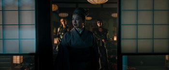 Movie still from “Snake Eyes” (2021), directed by Robert Schwentke – A group of women standing next to each other in a room; Medium shot, Over the shoulder angle