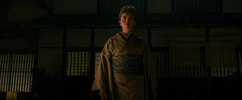 Movie still from “Snake Eyes” (2021), directed by Robert Schwentke – A man in a kimono standing in front of a building; Medium shot, Low angle