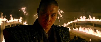 Movie still from “Snake Eyes” (2021), directed by Robert Schwentke – A man in a black and gold jacket looking at the camera; Close Up shot, Low angle