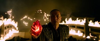 Movie still from “Snake Eyes” (2021), directed by Robert Schwentke – A man holding a glowing red object in his hand; Close Up shot, High angle