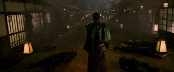 Movie still from “Snake Eyes” (2021), directed by Robert Schwentke – A man standing in the middle of an alley way; Wide shot, Over the shoulder angle