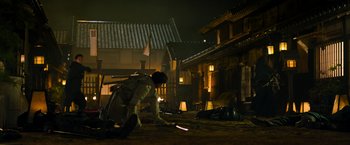 Movie still from “Snake Eyes” (2021), directed by Robert Schwentke – A man in a white suit is sweeping the ground; Extreme Wide shot, High angle