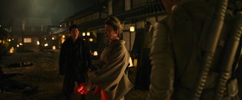 Movie still from “Snake Eyes” (2021), directed by Robert Schwentke – An older woman in a kimono is holding a red lantern; Medium shot, Over the shoulder angle