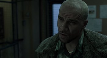 Movie still from “Snatch” (2000), directed by Guy Ritchie – A man with a shaved head and a beard; Close Up shot, Low angle