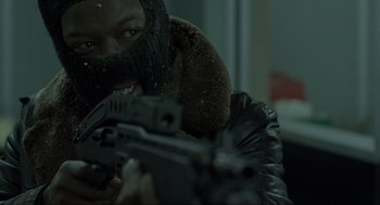 Movie still from “Snatch” (2000), directed by Guy Ritchie – A man in a bear costume holding a gun; Close Up shot, Over the shoulder angle