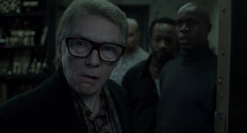 Movie still from “Snatch” (2000), directed by Guy Ritchie – A group of men standing next to each other in a room; Close Up shot, Over the shoulder angle