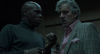 Movie still from “Snatch” (2000), directed by Guy Ritchie – Two men standing next to each other in front of a microphone; Close Up shot, Low angle