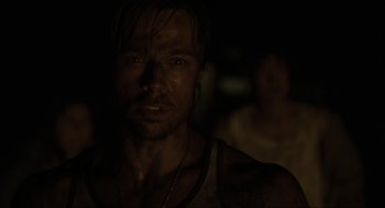 Movie still from “Snatch” (2000), directed by Guy Ritchie – A person wearing a tank top; Close Up shot, Over the shoulder angle