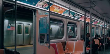 Movie still from “Sneakerella” (2022), directed by Elizabeth Allen Rosenbaum – A subway train with a man standing on the platform; Extreme Wide shot, High angle