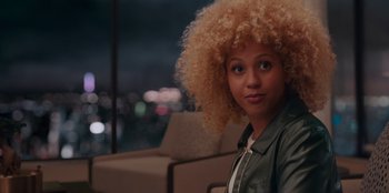 Movie still from “Sneakerella” (2022), directed by Elizabeth Allen Rosenbaum – A woman sitting in front of a window; Close Up shot, Over the shoulder angle