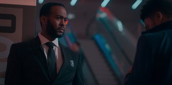 Movie still from “Sneakerella” (2022), directed by Elizabeth Allen Rosenbaum – A man in a suit and a tie; Close Up shot, Low angle