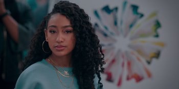 Movie still from “Sneakerella” (2022), directed by Elizabeth Allen Rosenbaum – A person with long curly black hair; Close Up shot, Over the shoulder angle