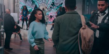 Movie still from “Sneakerella” (2022), directed by Elizabeth Allen Rosenbaum – A woman in a blue top is talking to a man in a blue jacket; Medium shot, Over the shoulder angle