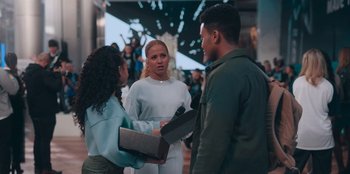 Movie still from “Sneakerella” (2022), directed by Elizabeth Allen Rosenbaum – A group of people standing around each other; Medium shot, Over the shoulder angle