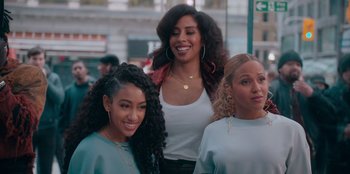 Movie still from “Sneakerella” (2022), directed by Elizabeth Allen Rosenbaum – A group of women standing next to each other on the street; Medium shot, Over the shoulder angle