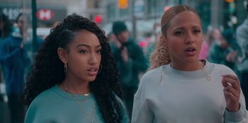 Movie still from “Sneakerella” (2022), directed by Elizabeth Allen Rosenbaum – Two young women walking down the street in a city; Close Up shot, Over the shoulder angle