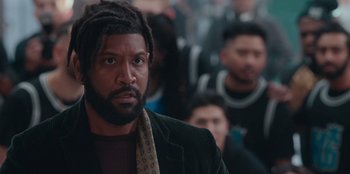 Movie still from “Sneakerella” (2022), directed by Elizabeth Allen Rosenbaum – A person with a dreadlocks; Close Up shot, Over the shoulder angle