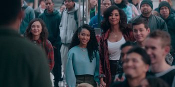 Movie still from “Sneakerella” (2022), directed by Elizabeth Allen Rosenbaum – A group of people standing around each other in a room; Medium shot, Over the shoulder angle