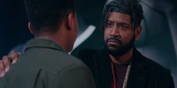 Movie still from “Sneakerella” (2022), directed by Elizabeth Allen Rosenbaum – A man with a beard is talking to another man; Close Up shot, Over the shoulder angle