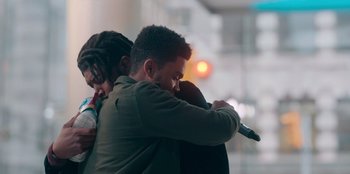 Movie still from “Sneakerella” (2022), directed by Elizabeth Allen Rosenbaum – A man and a woman hugging each other in a room; Medium shot, Over the shoulder angle