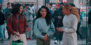 Movie still from “Sneakerella” (2022), directed by Elizabeth Allen Rosenbaum – A group of people standing on the sidewalk; Medium shot, Over the shoulder angle