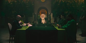 Movie still from “Sniper: G.R.I.T. - Global Response & Intelligence Team” (2023), directed by Oliver Thompson – A group of people sitting around a table; Wide shot, Over the shoulder angle