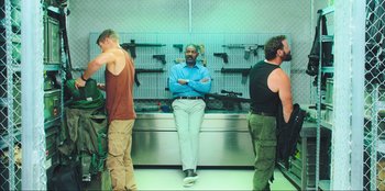 Movie still from “Sniper: G.R.I.T. - Global Response & Intelligence Team” (2023), directed by Oliver Thompson – A group of men standing next to each other in a room; Wide shot, Low angle