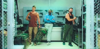 Movie still from “Sniper: G.R.I.T. - Global Response & Intelligence Team” (2023), directed by Oliver Thompson – A group of men standing next to each other in a room; Wide shot, Low angle