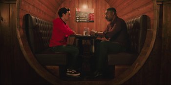 Movie still from “Sniper: G.R.I.T. - Global Response & Intelligence Team” (2023), directed by Oliver Thompson – Two people sitting at a booth in a restaurant; Medium shot, Low angle