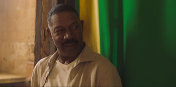 Movie still from “Sniper: G.R.I.T. - Global Response & Intelligence Team” (2023), directed by Oliver Thompson – A person wearing a shirt; Close Up shot, Low angle