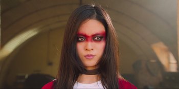 Movie still from “Sniper: G.R.I.T. - Global Response & Intelligence Team” (2023), directed by Oliver Thompson – A woman with red makeup on her face; Close Up shot, Low angle
