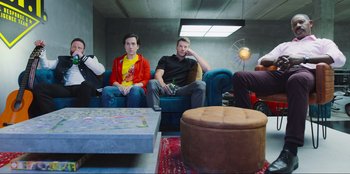 Movie still from “Sniper: G.R.I.T. - Global Response & Intelligence Team” (2023), directed by Oliver Thompson – A group of people sitting in a room; Wide shot, Low angle
