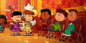 Movie still from “Snoopy Presents: For Auld Lang Syne” (2021), directed by Clay Kaytis – A group of people sitting on chairs in a room; Extreme Wide shot, High angle