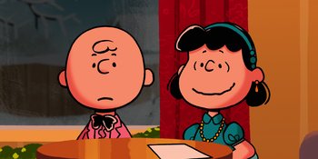 Movie still from “Snoopy Presents: For Auld Lang Syne” (2021), directed by Clay Kaytis – A charlie brown and lucy cartoon character sitting at a table; Medium shot, High angle